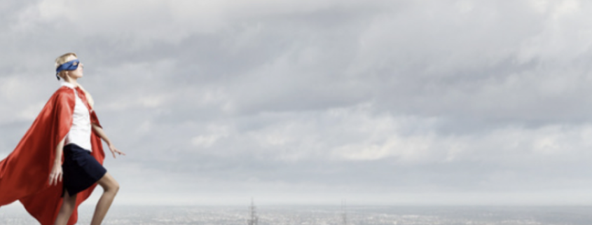 Business person in superhero pose overlooking a cityscape, symbolizing the strength and flexibility of cloud infrastructure to support and elevate businesses in dynamic environments.